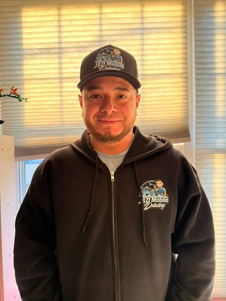 Josue Escobar, owner of J&D Mobile Detailing, in his J&D cap and hoodie